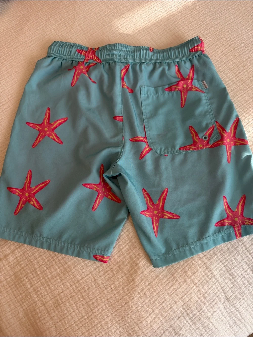 Kids Teal Swim Trunks with Pink Starfish Print